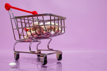 A small supermarket cart with pills. viruses