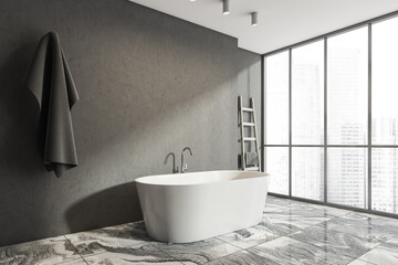 Dark bathroom interior with bathtub and empty concrete wall