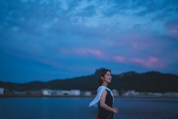 Fototapeta premium 夕暮れの海の女性