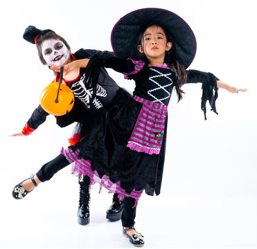 Portrait Pair Of Little Girls In Halloween And Carnival Costume Isolated On White Background