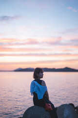 夕暮れの海の女性