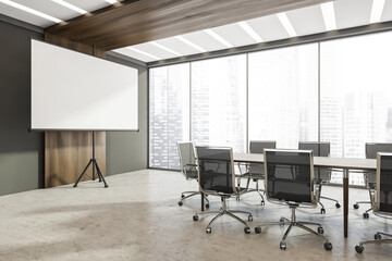 Panoramic grey meeting room with flip chart