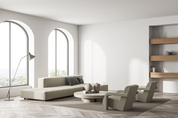 White living room with arch windows and niche bookshelves. Corner view.