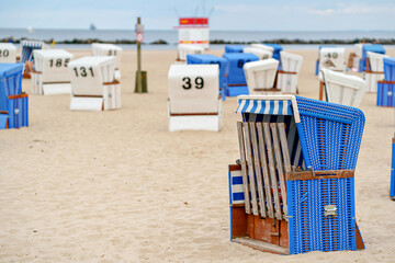 Traditional German roofed wicker beach chairs on the beach of Baltic sea. Beach with chairs on...