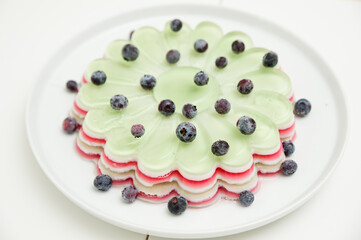 Jelly cake with blueberries. Striped and sweet dessert.
