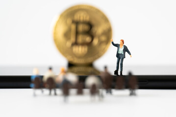Miniature people Business man speech presentation on podium on public stage with Golden Bitcoin background Success Strategy Business Planning and New Blockchain Technology Money transfer concepts
