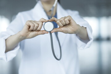 Close-up of doctor holding stethoscope. Health care concept