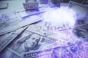 Double exposure of man wearing VR glasses drawing over usa dollars bill background. Concept of virtual reality.