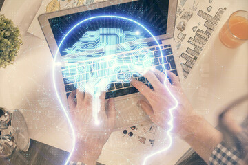 Obraz na płótnie Canvas Double exposure of man's hands typing over computer keyboard and brain hologram drawing. Top view. Ai and data technology concept.