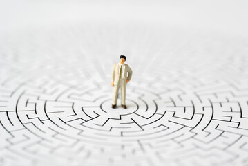 Miniature Business people office man stand center of maze thinking business plan and how to solve problem using for Accounting Financial Banking business growth development and Commerce Strategy Plan