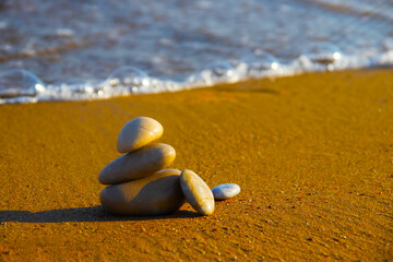 Fototapeta na wymiar sea ​​stones on the sandy shore