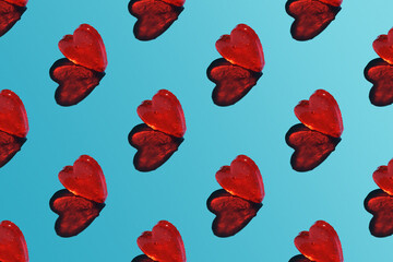 A repeating heart pattern on a blue background with a sharp shadow.