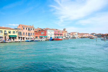 Beautiful view of Venice with coloured building on the seaand boats. Turist place for family vacations. Sea, sky, summer and travelling.