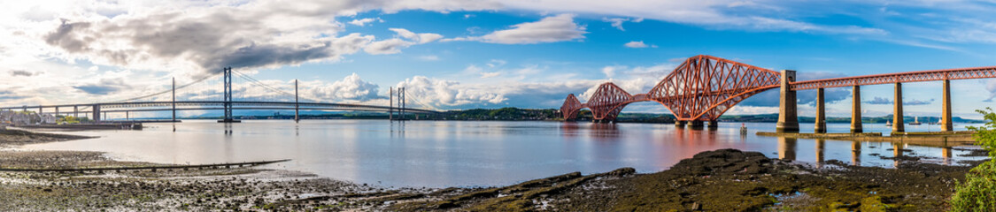 A panorama view from Queensferry of the bridges over the Firth of Forth, Scotland on a summers day