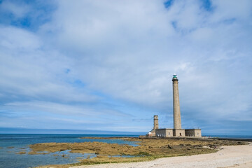 High lighthouse in Normandy, north of France. Family vacations in beautiful scenario.