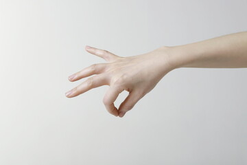 Cropped image of woman hand picking up something