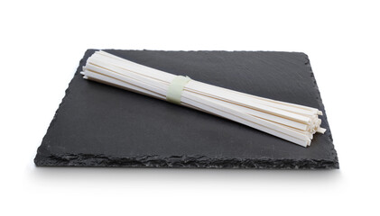 Rice noodles on slate plate isolated.