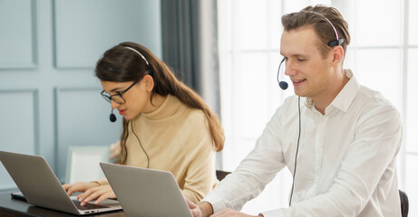 group of operator man and woman working with headset and laptop computer in a call centre . customer service help desk online . teamwork service