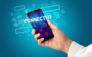 Hand using smartphone with social media concept