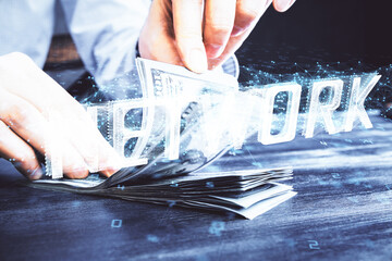 Double exposure of technology drawing hologram and us dollars bills and man hands. Data concept