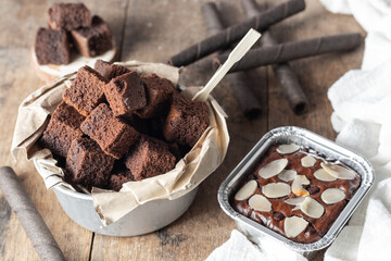 Chocolate brownie cake, dessert with milk on a dark background on a wooden table.