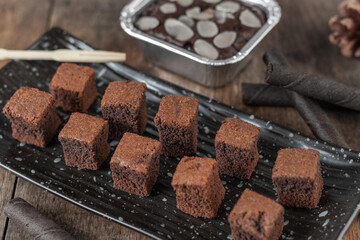 close up Chocolate brownie cake, dessert with milk on a dark background on a wooden table.