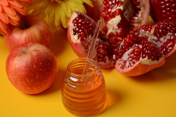Rosh hashanah (jewish New Year holiday) concept. Traditional symbols-Honey jar, apples and pomegranate