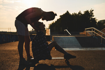 Couple kissing on sunset at skatepark