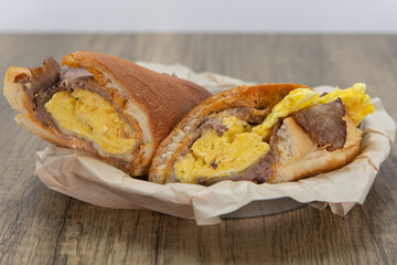 Steak and scrambled eggs sandwich loaded with all the good fixings to completely fill any appetite for a meal