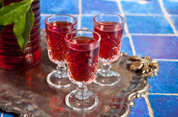 glasses of cherry brandy liqueur with ripe berries