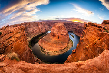 An evening sunset shot of Horseshoe Bend -- a horseshoe shaped canyon high above the Colorado River near Lake Powell and the Grand Canyon.