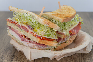 Layered turkey, salami, and provolone cheese sandwich loaded with all the good fixings to completely fill any appetite for a meal