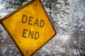 An old Dead End on a snowy rural road in Bailey, Colorado during the middle of winter.