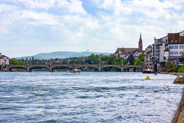 Panoramic view over Rhine river in Basel with Mittlere Brücke (middle bridge) and red Basler...