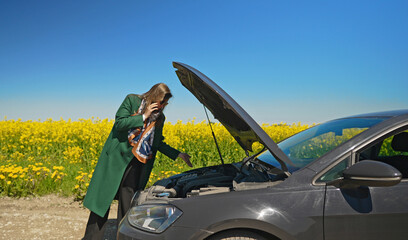 Woman near broken car calling for help.