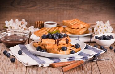 Waffles with blueberries and chocolate cream. 