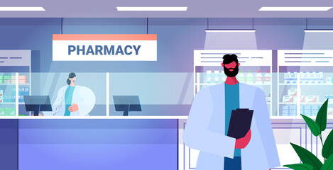 male doctor pharmacist with clipboard standing at pharmacy counter modern drugstore interior medicine