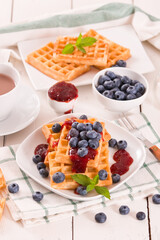 Waffles with blueberries and jam. 