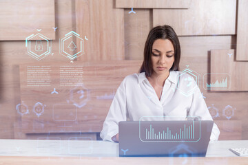 Attractive businesswoman in white shirt at workplace working with laptop to optimize development by...