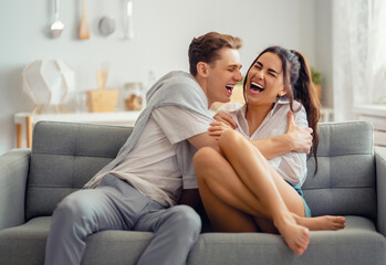 couple having fun and hugging at home.