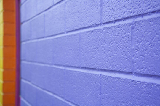 Purple wall, angular view. Brightly coloured wall, blurred background