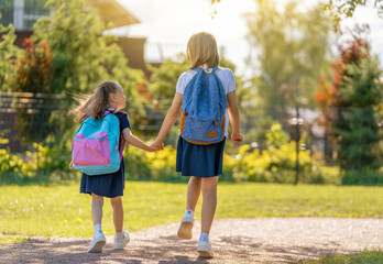 Girls with backpack are going to school - obrazy, fototapety, plakaty