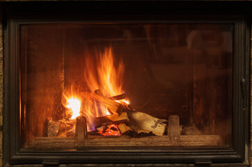 dark fireplace with burning wood