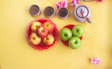 Group of red and green Apple put on red dish with auspicious Chinese words on bottom