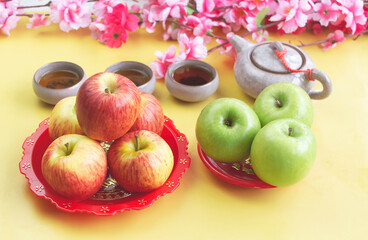 Group of red and green Apple,Orange fruit put beside Chinese tea cup.