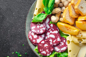 snack plate sausage, meat, cheese, nuts, peach, fruit, toast bread smoked or dry-cured meal snack on the table copy space food background rustic. top view