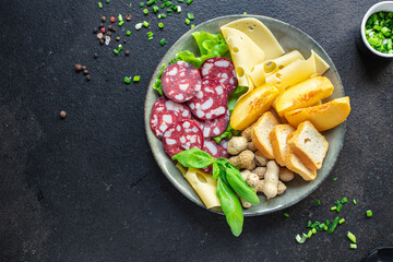 snack plate sausage, meat, cheese, nuts, peach, fruit, toast bread smoked or dry-cured meal snack on the table copy space food background rustic. top view