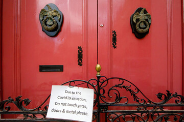 Covid19 warning on an old door in Imdina Malta.