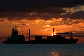 Container ship against the sunrise