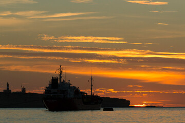 Fototapeta premium Sunrise over Marsaxlokk bay south of Malta